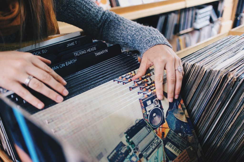 woman choosing vinyl records