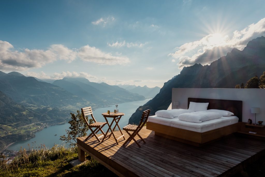bed overlooking river and mountains