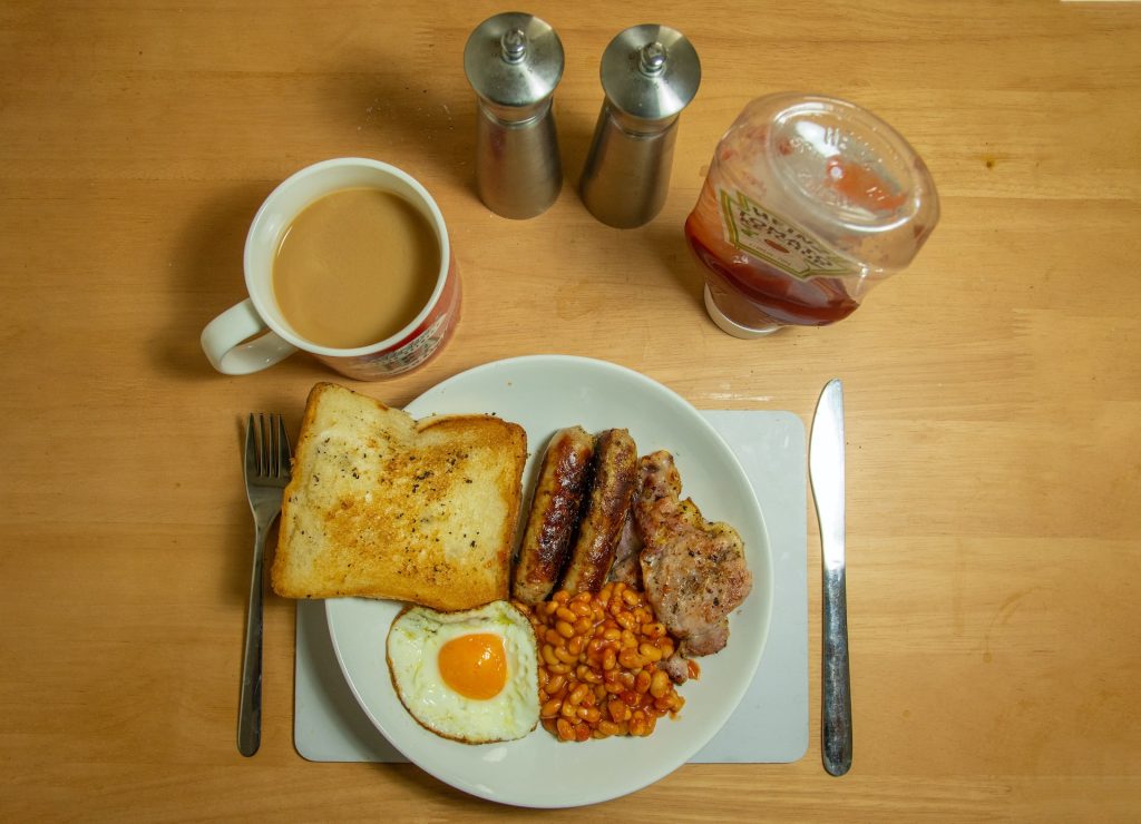breakfast sausages toast eggs and beans on plate
