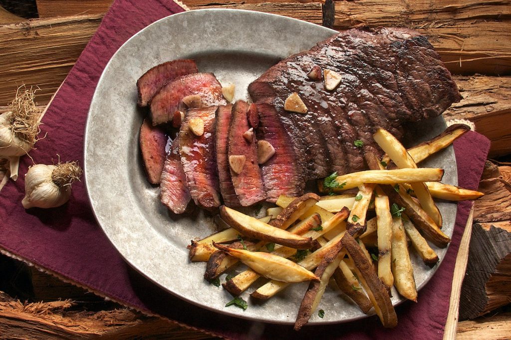 beef steak served with fries